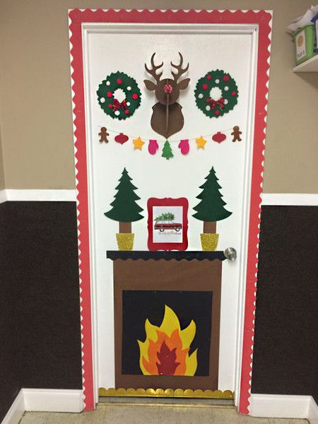 a decorated door with a fireplace and christmas wreaths on the front, along with other decorations