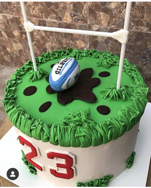 a football themed cake is displayed on a table