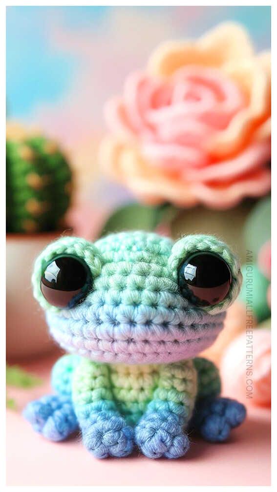 a small crocheted frog sitting on top of a table