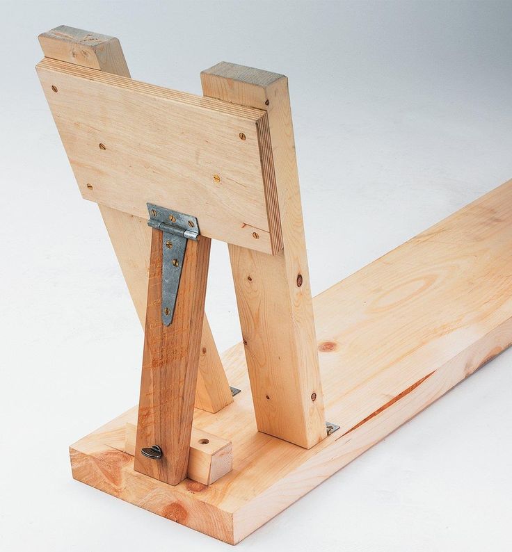 a piece of wood that has been made to look like an easel with metal handles