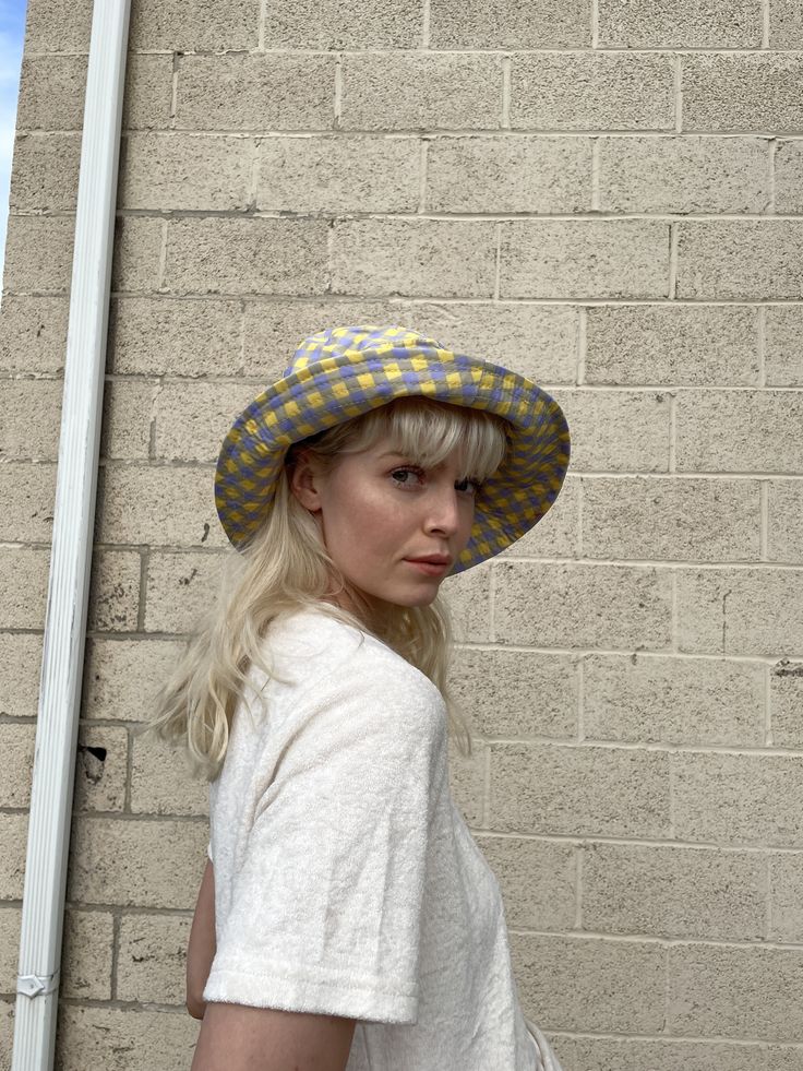 Yellow + Lavender Plaid Bucket Hat with adjustable string on the inside. one size Model is 5'9" Adjustable Summer Bucket Hat One Size, Adjustable One Size Bucket Hat For Summer, Adjustable One-size Sun Hat For Spring, Adjustable Lavender Hat With Curved Brim, Retro Yellow Bucket Hat For Spring, Retro Adjustable Bucket Hat For Summer, Adjustable Retro Bucket Hat For Summer, Retro Adjustable Hats For Festivals, Trendy Adjustable Bucket Hat