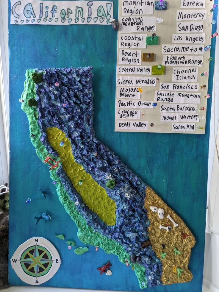 a bulletin board that is covered in blue and green paper with the map of california on it