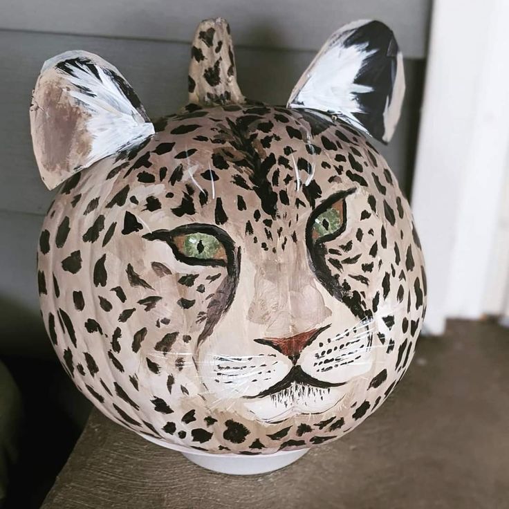 a ceramic leopard head sitting on top of a table