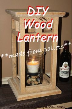 diy wood lantern made from pallets with candle inside and wine bottle in the background