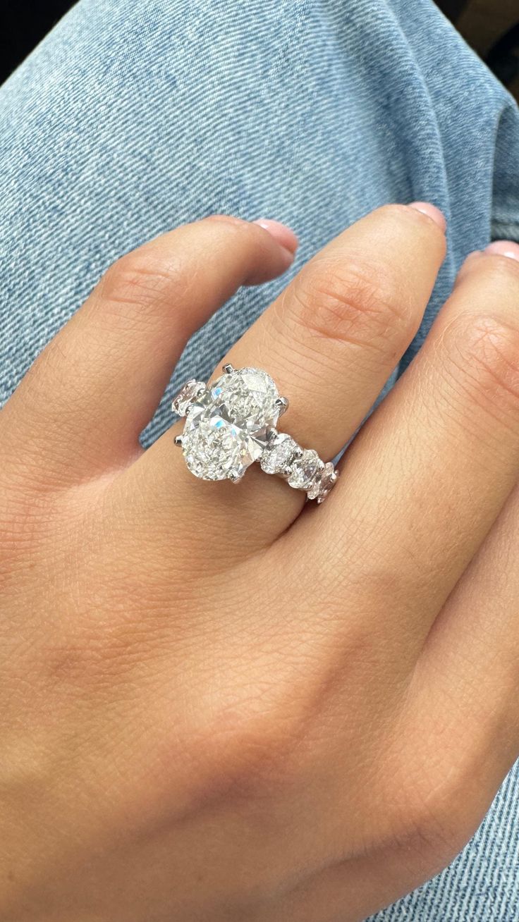 a woman's hand with a diamond ring on it