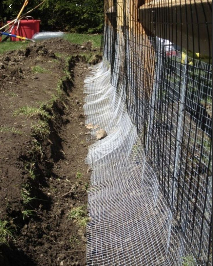 a fence that is next to some dirt