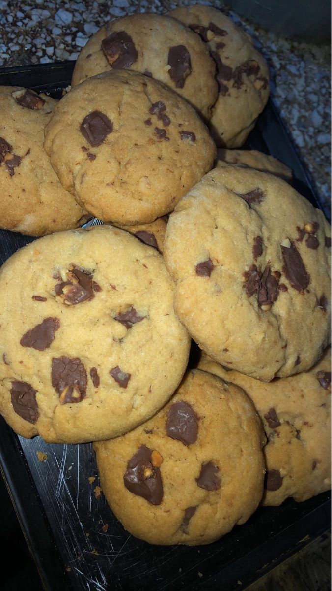 a pile of chocolate chip cookies sitting on top of a counter