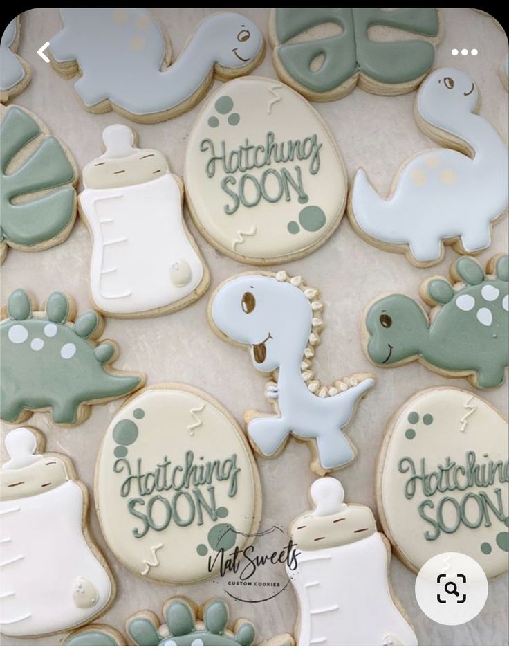 some cookies that are on top of a table with writing in the middle and other decorations around them