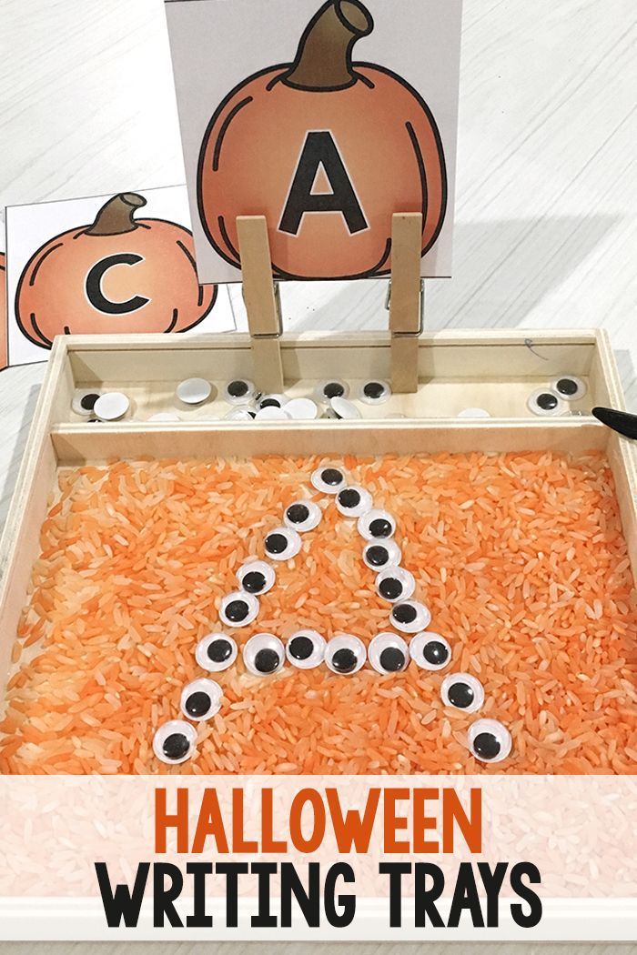 a halloween writing tray with pumpkins and letters on it, including the letter a