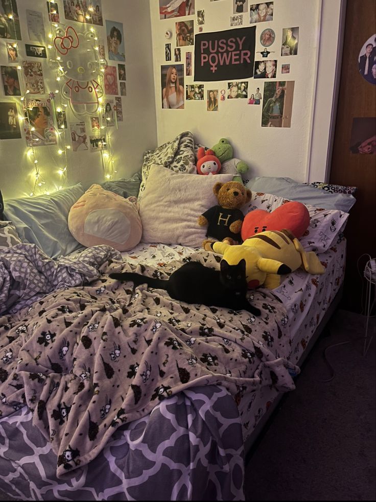 a bed with stuffed animals on it in a room filled with pictures and lights at the headboard