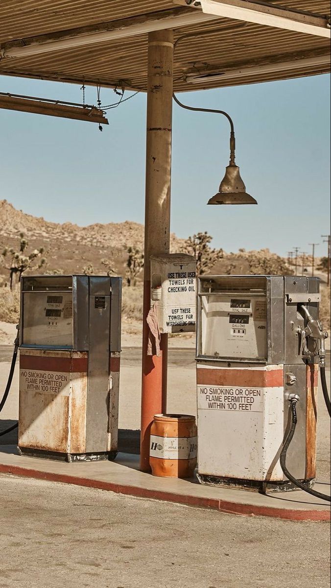 an old fashioned gas station with two machines