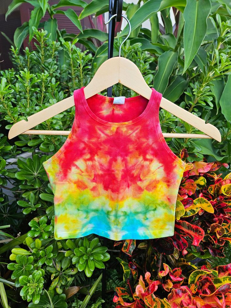 Hand Dyed- This one of a kind psychedelic rainbow crop top has been hand-dyed in beautiful Sarasota, Fl with red, yellow, blue and green colors. These boho tie dye x small crop tops are a unique retro outfit to wear to a concert or hippie festival. They are great to wear to yoga, pilates, and the gym. Support eco friendly made in USA clothing! Feel good knowing that you are making a difference by purchasing fair trade ethical fashion. Perfect gift for a teen girl who wears junior's clothing or a student at university or college.  Dyes- High-quality procion dyes from Dharma Trading Company. Top- 92% Cotton, 8% Elastane. Very soft mid weight cotton. Slight Stretch. Sourced from Dharma Trading. Made in the U.S.A.  Sizing- X Small (Women's) or Medium (Juniors) - Length 13 inches Width 13.5 inc Stretch Multicolor Crop Top For Music Festival, Multicolor Stretch Cotton Crop Top, Fitted Rainbow Crop Top For Summer, Fitted Multicolor Racerback Tank Top, Fitted Rave Tank Top For Summer, Fitted Green Tank Top For Festival, Fitted Multicolor Cotton Tank Top, Multicolor Rainbow Print Tops For Festivals, Festival Multicolor Tops With Rainbow Print