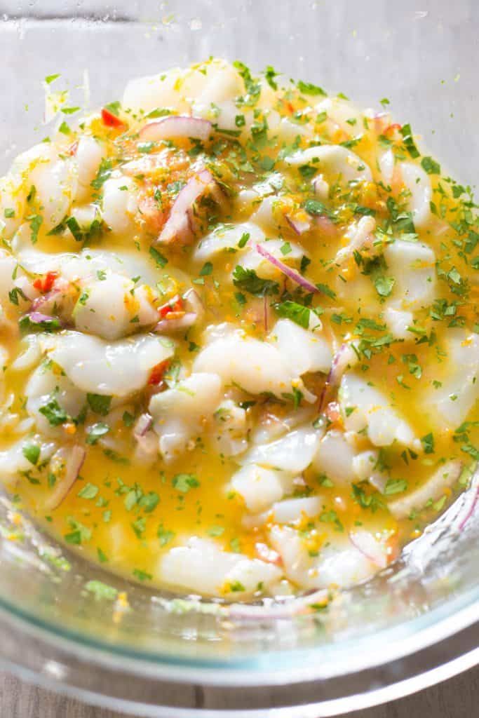 the best scallop cevichle with shrimp and parsley in a glass bowl