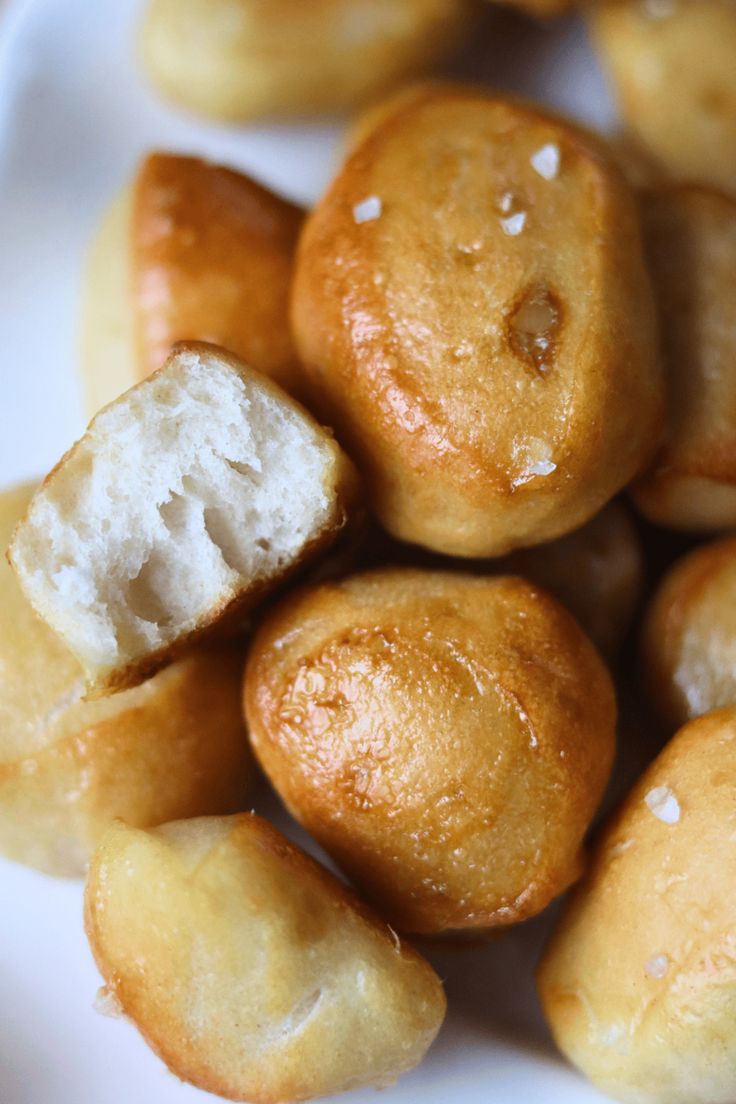 some bread rolls are on a white plate