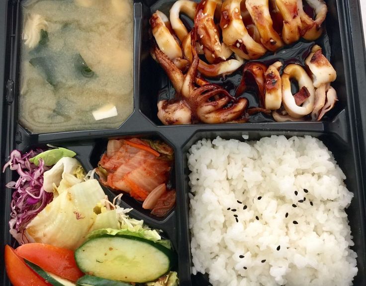 a bento box filled with rice, meat and veggies