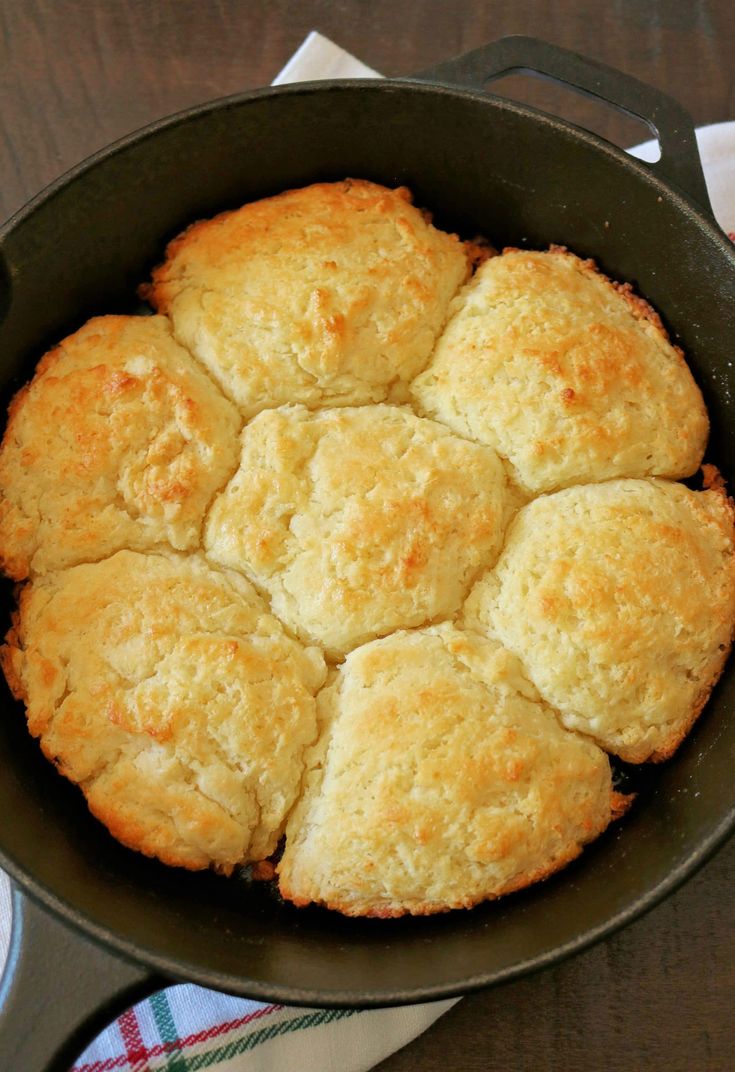 a pan filled with biscuits sitting on top of a table