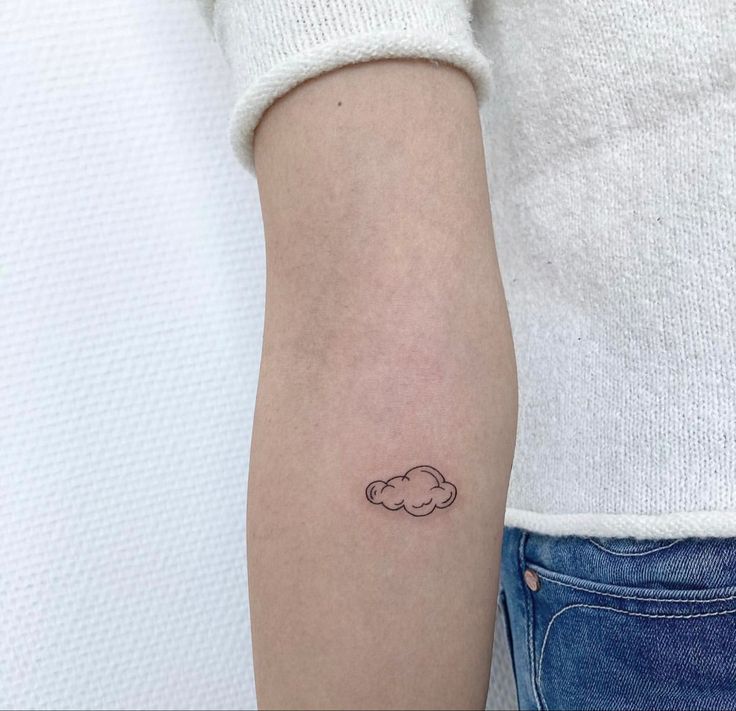 a small cloud tattoo on the left arm