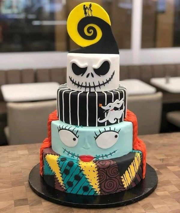 a three tiered cake decorated to look like jack skellingy from the nightmare