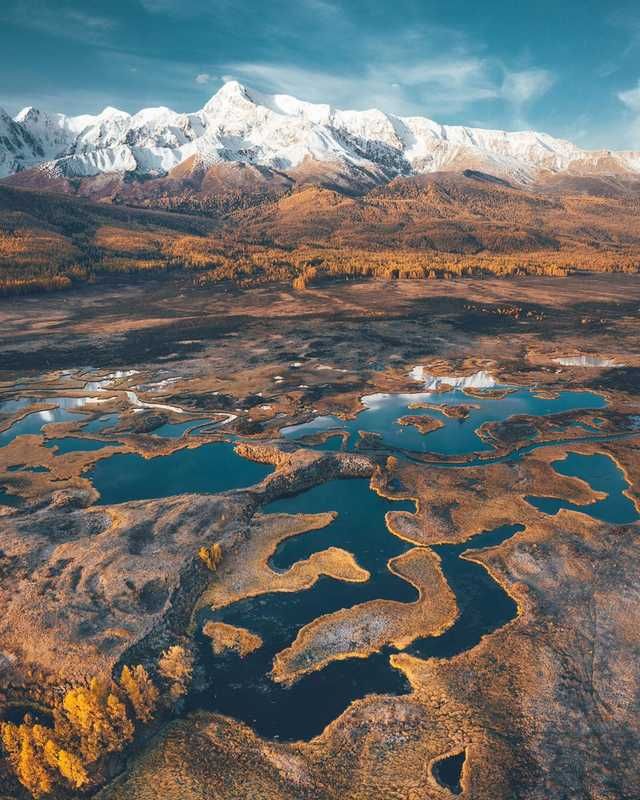 an aerial view of the mountains and lakes