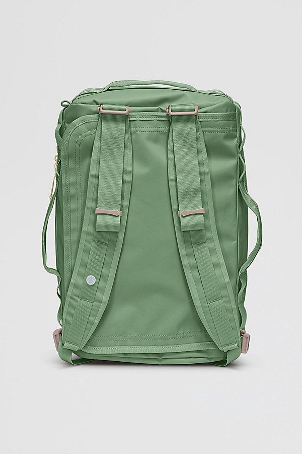 the back view of a green backpack with straps on it, sitting in front of a white background