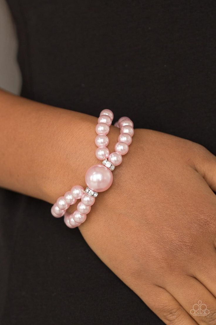 Joined at the center by an oversized pink pearl and a pair of white rhinestone encrusted rings, classic pink pearls are threaded along stretchy bands around the wrist for a timelessly layered look.   Sold as one individual bracelet. Homecoming Jewelry, Pink Pearl Bracelet, Aka Sorority, Formal Jewelry, Pink Pearls, Gamma Phi, Pink Box, Rhinestone Ring, Wedding Bridal Jewellery