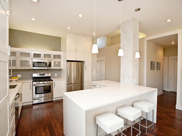 a kitchen with an island, stove and refrigerator in it's center area is shown