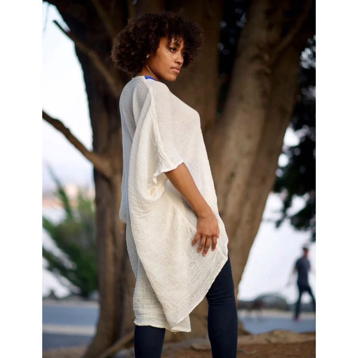 Boldly cozy with a boho twist. Simply-chic layering piece, that dresses up or down for any occasion. Off white with multi-color embroidered trim. 100% cotton V-Neck with a flattering drape. Embroidered Trim made by hand in Ethiopia.Tunic made in California.One size fits most --- One size fits most { the size is loose fit, it will fit from size 2 to size 12 } Machine wash in a delicate cycle or hand wash in cold water. Tumble dry on low heat for a crinkle look. White Cotton Cover-up For Day Out, White Cotton Spring Cover-up, Spring White Cotton Cover-up, Cotton V-neck Cover-up For Day Out, V-neck Cotton Cover-up For Day Out, Cotton Tunic For Day Out With Relaxed Fit, Cotton Tunic With Relaxed Fit For Day Out, Spring Cotton Tunic Cover-up, Casual White Tunic Cover-up