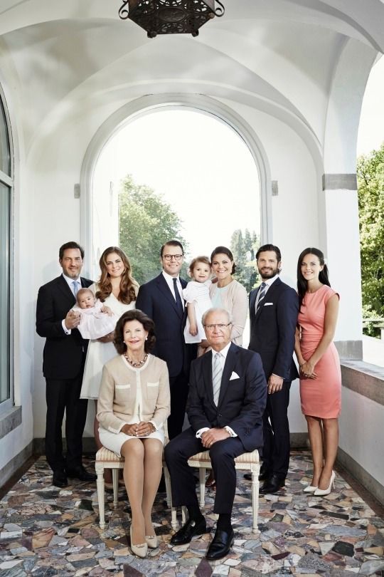 a group of people standing and sitting in front of a window