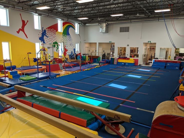 an indoor trampoline gym with blue and yellow mats