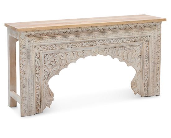 an ornate wooden table with carvings on the top and bottom, against a white background