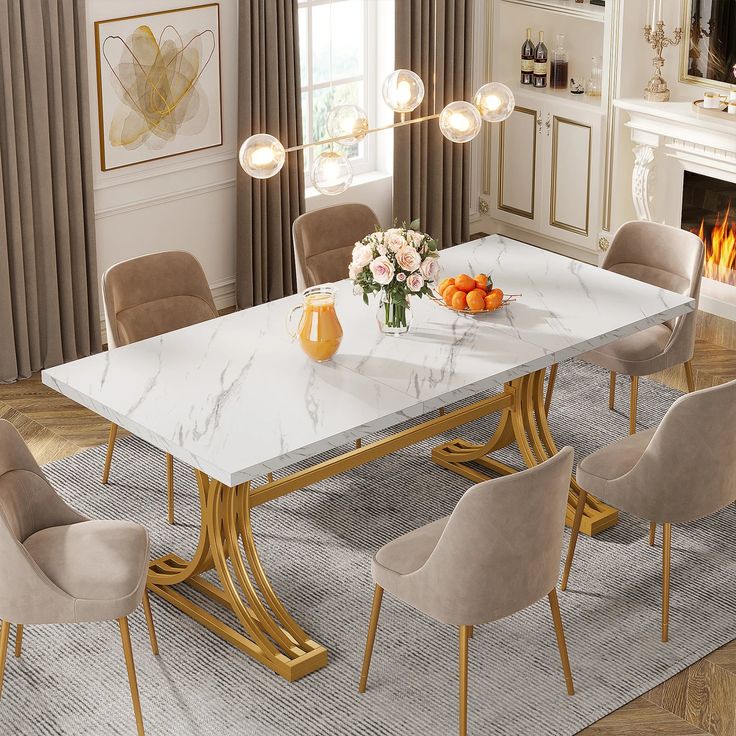 a marble dining table surrounded by beige chairs and gold accents, with a fireplace in the background