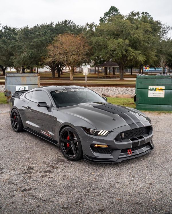 a gray mustang parked in a parking lot