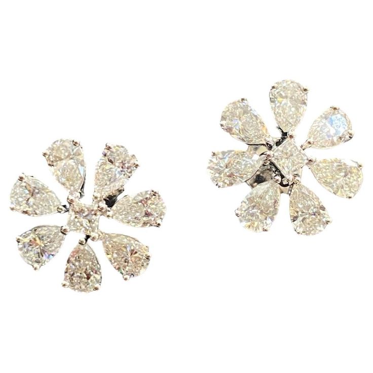 This elegant stud earrings feature a remarkable 4.50 carats of pear princess natural diamonds, set within a beautiful big flower design crafted from 14K white gold! Specifications : Diamond Weight : 4.50 Cts [4.20 Cts Pear + 0.30 Cts Princess] Diamond Shape : Pear & Princess Diamond Color Grade : F Diamond Clarity Grade : VS1 Gold Color : White Gold Gold Purity : 14K Closure : Screw Back (pierced) Style : Stud Earrings Width : 16.10 MM SKU : E-736 Our Promise : 1.) HIGH Quality Products. 2.) All our products are accomanpied with Hallmark Stamps and Certificates. 3.) We have all sizes, shapes, color, clarity GIA & IGI Ceritifed Diamonds Available. 4.) We do make Custom Designs. Please contact for Custom Designs. 5.) Customization like Ring Size, Length can be done at Free of Cost. 6.) Free Big Flower Design, Diamond Color Grade, Flower Stud Earrings, Flower Stud, Princess Diamond, Big Flowers, Flower Earrings Studs, Flower Studs, Diamond Clarity