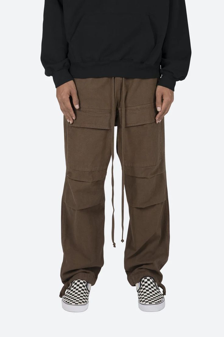 the Utility Snap Cargo Pants are designed with a relaxed fit throughout the leg, with large cargo pockets located on the front, an elastic waistband, yellow elastic drawcord, zipper pockets at the side seam and finishing off with contrasting paneling on the inseam. details relaxed fit 100% cotton model is 6’1, 140 lbs Utility Cargo Pants, 140 Lbs, Fuzzy Cardigan, Denim Patches, Denim Flares, Knit Shorts, Military Fashion, Black Hoodie, Black Denim