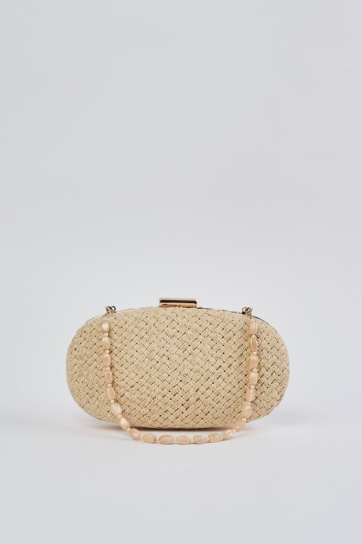 In a Natural tone, this versatile clutch is an ideal summer accessory. With a hard casing featuring a hand woven outer, we adore the detachable beaded shell strap and easy metal snap closure. Crafted to complement our Corsica collection, this charming oval-shaped bag is a must-have clutch of the season. Elegant Clutch As Fashion Accessory For Spring, Elegant Spring Fashion Accessory Clutch, Elegant Beige Clutch For Summer, Chic Summer Clutch For Fashion, Chic Straw Bag With Pearl Handle, Beaded Beige Straw Bag, Chic Beige Woven Clutch, Elegant Woven Clutch For Vacation, Beaded Rectangular Beach Clutch