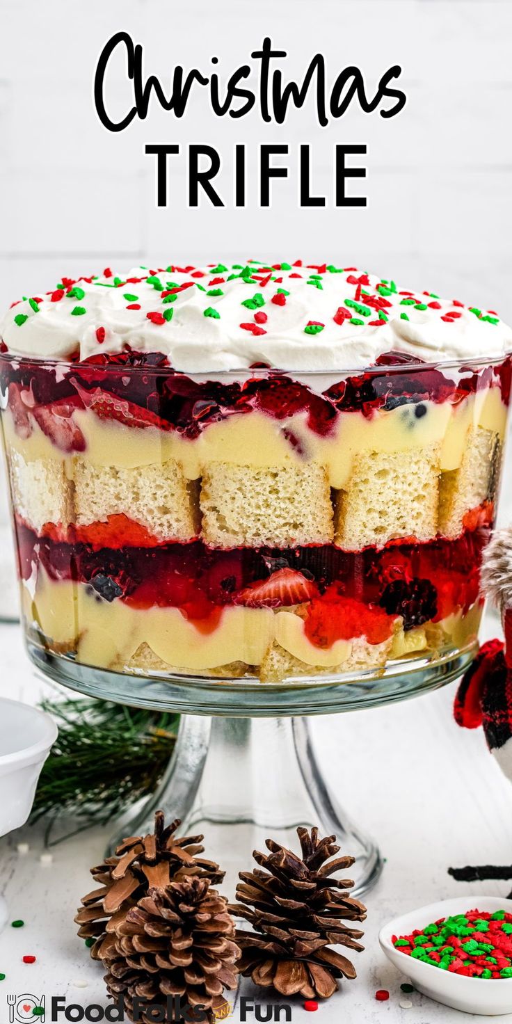 a christmas trifle cake with white frosting and berries on top