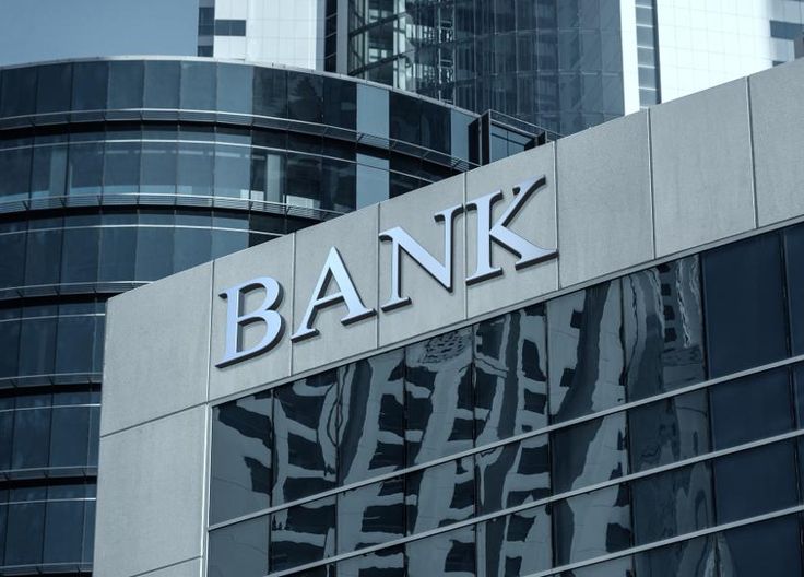 the bank sign on top of an office building