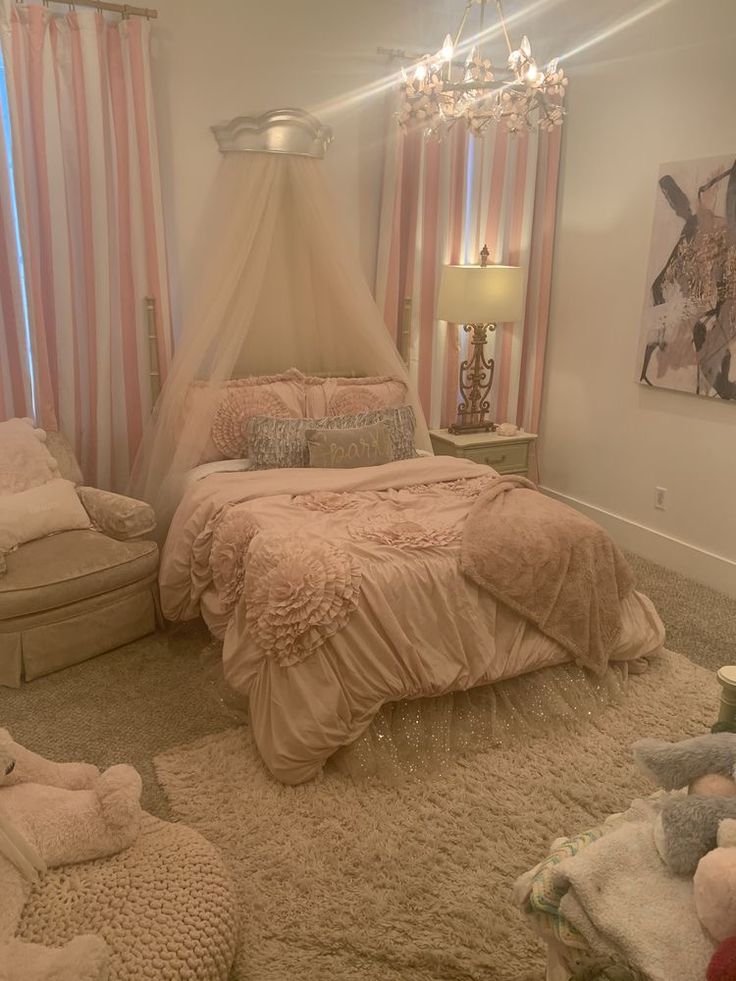 a bed room with a neatly made bed and pink curtains