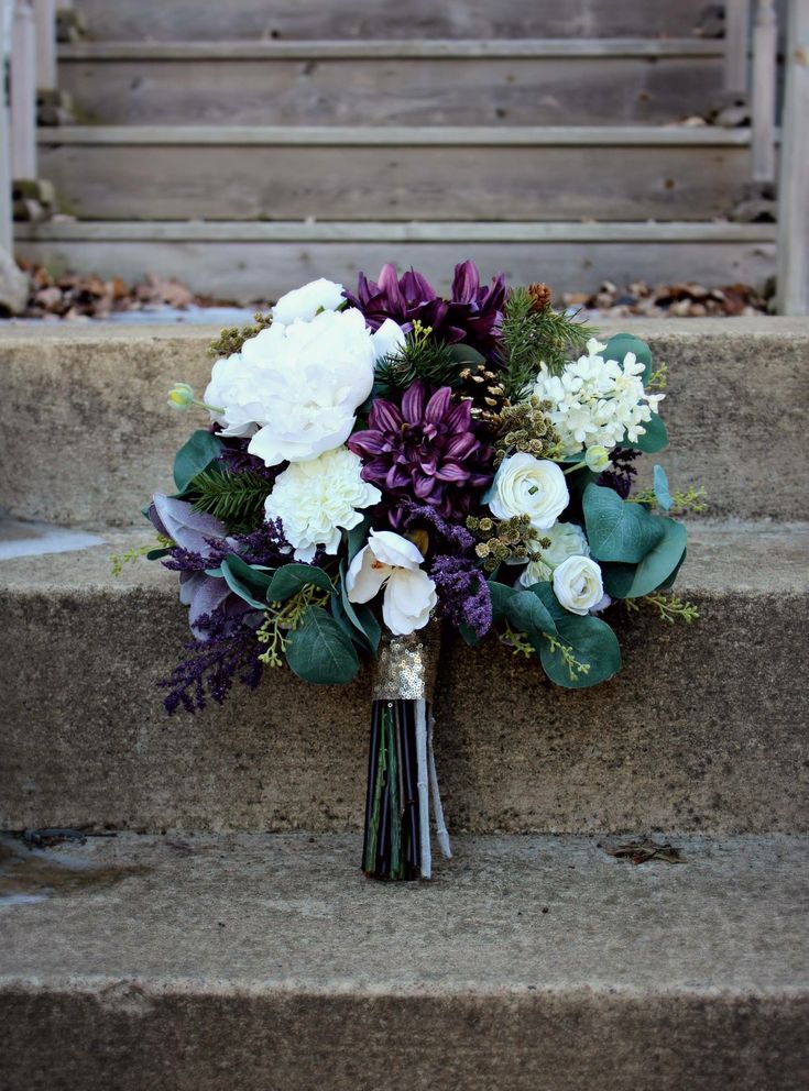 a bridal bouquet sitting on some steps