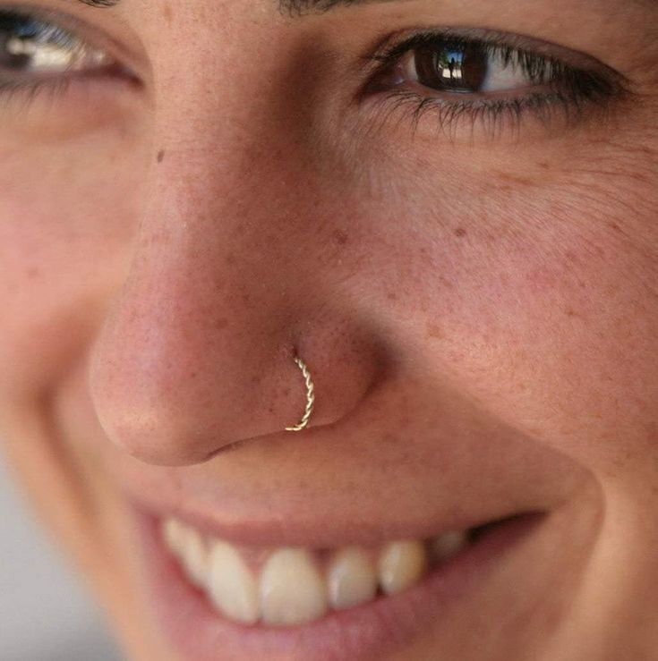 a close up of a person with a nose ring