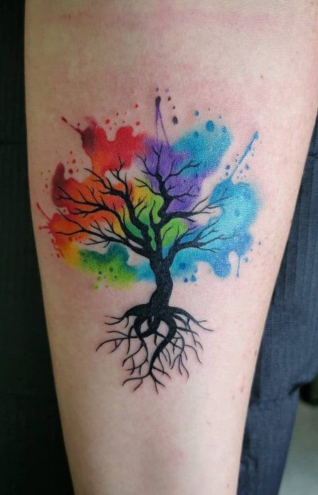 a colorful tree tattoo on the leg