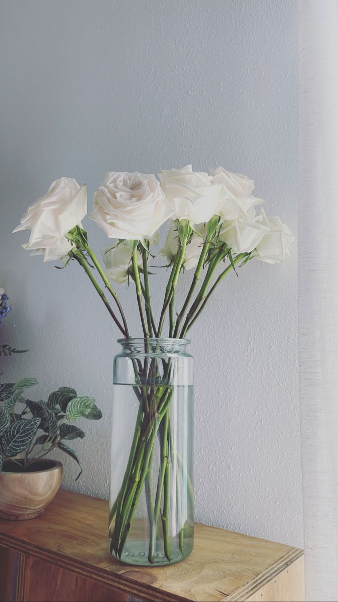 some white flowers are in a glass vase