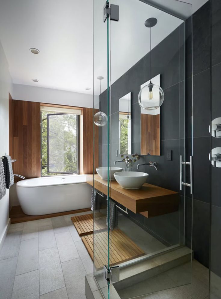 a bath room with a sink and a bath tub next to a window in it