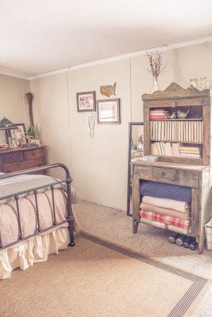 a bed room with a neatly made bed and a book shelf on the wall next to it