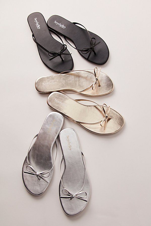 A staple sunny-day style gets a femme touch with these flip-flops from Seychelles, featured in a monochrome, vegan leather style with a dainty bow detail for the perfect added accent. **Features:** Slip-on style, backless design, vegan leather uppers, round open toe, thin thong straps, bow detail, flat sole **Why We | Miley Bow Sandals by Seychelles at Free People in Black, Size: US 8.5 Classy Flip Flops, Valentino Flip Flops Outfits, Heel Flip Flops, Summer Outfit Shoes, Sandals Flat, Flats Sandals, Church Shoes, Beach Sandals Outfit, Summer Sandals