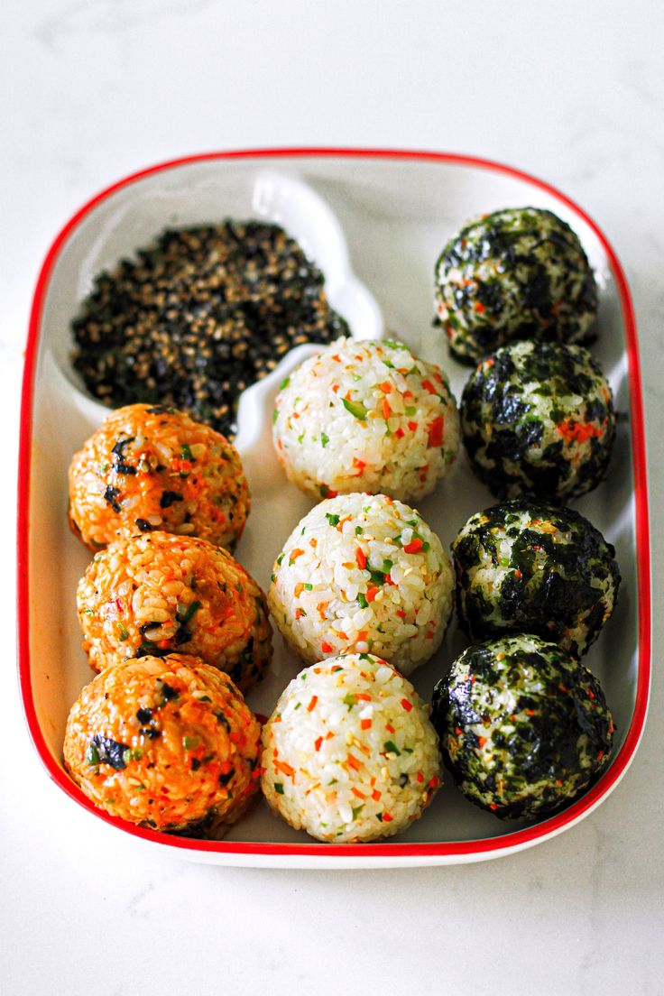 there are many different types of food in the bowl on the table, including rice balls and broccoli