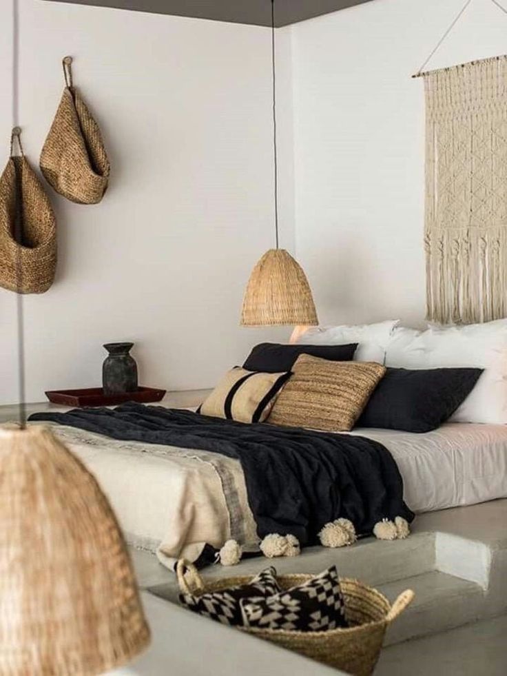 a bed room with a neatly made bed and baskets hanging on the wall above it