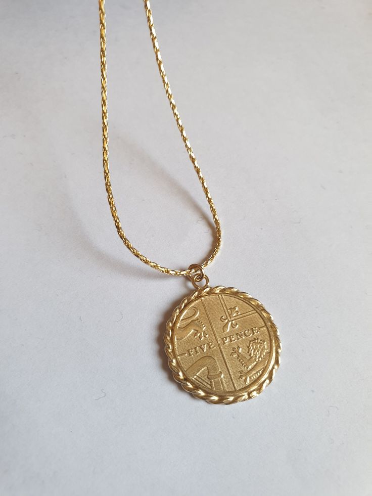 Solid gold coin necklace, gold coin pendant necklace, antique necklace, British coin gold necklace, 14k gold necklace Solid gold 14k necklace with an old british gold coin pendant, great for everyday wear, unique and beautiful. The chain is made of 14k solid gold and available in a few styles and lengths and the pendant is an original coin which I decorate with twisted gold wires and is available in 9k or 14k solid gold. Dimensions: The coin pendant's diameter is about 0.75 inch (2 cm). There ar Gold Coin Necklace With 14k Stamp, Gold Coin Pendant Necklace Stamped 14k, Gold Coin Necklace With Stamped 14k Round Pendant, Engraved Medallion Coin Necklace In Yellow Gold, Gold Hallmarked Round Pendant Coin Necklace, Gold Round Coin Necklace Stamped 14k, Yellow Gold Engraved Medallion Coin Necklace, Yellow Gold Coin Necklace With Stamped 14k Round Pendant, Yellow Gold Medallion Necklace With Coin Pendant