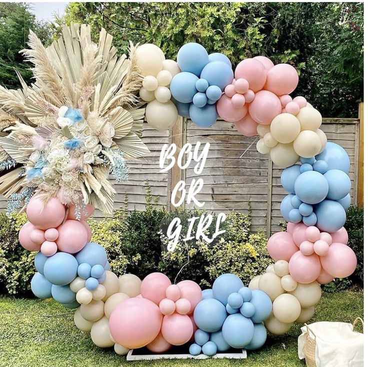 a wreath made out of balloons with the words boy or girl in white and blue