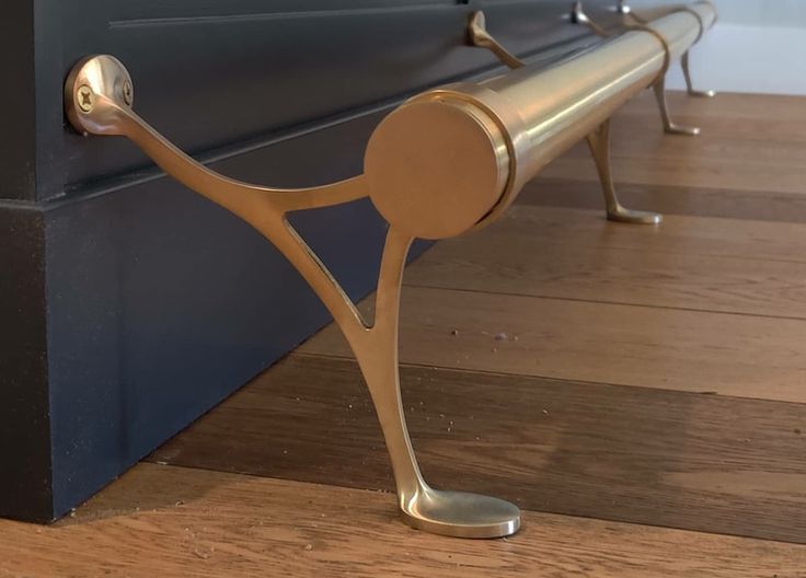 a metal bench sitting on top of a hard wood floor next to a door way